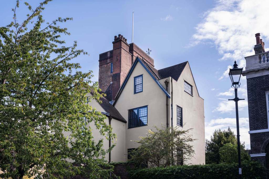 Historic North Bridge House Canonbury school building surrounded by trees on Canonbury Square, with traditional architecture and a brick tower under a blue sky.